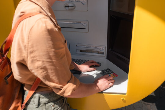 Anonymous woman using ATM keyboard in the city 
