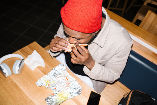 Young man enjoying fast food lunch