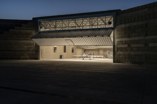 Evening Hangar with Aircraft in Warm Interior Light