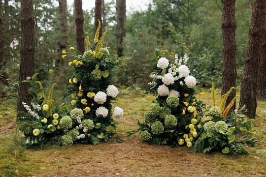 Beautiful decoration composition from flowers in blurred forest