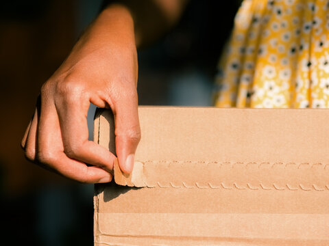 Woman unpacking box from delivery 