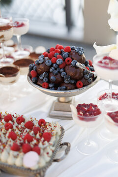 Partial of decorated table with delicious sweet cookies and berries
