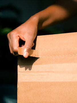 Woman opening box after delivery 
