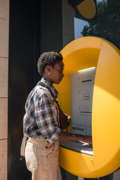 Black woman using ATM 