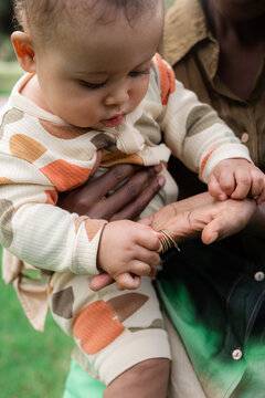 Baby studying mom's hand 