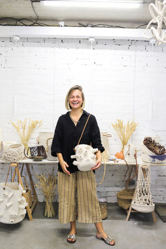 A woman is giving a master class on making bags.
