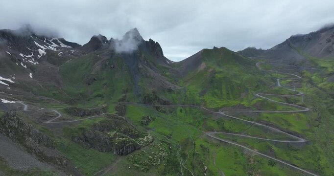 Aerial view of beautiful high altitude grassland mountain and winding road  landscape