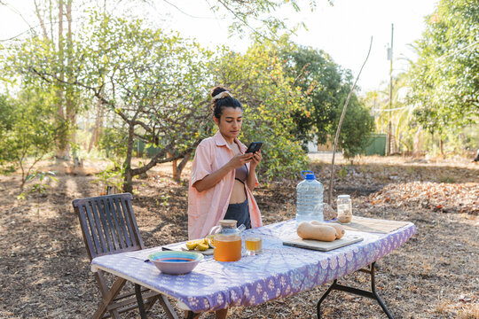 A person uses their smartphone during an outdoor rural activity.