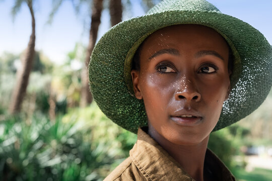 Portrait of woman in sunhat in park 