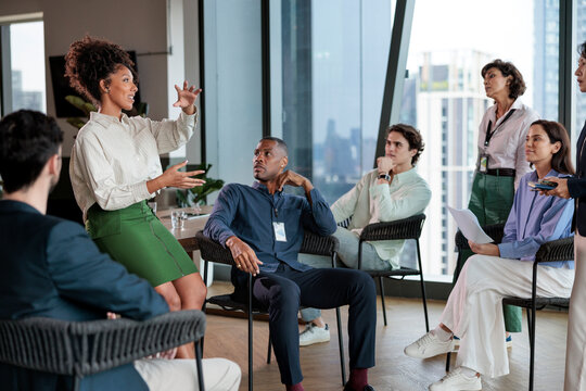 Diverse team meeting with a presenter in a modern office.