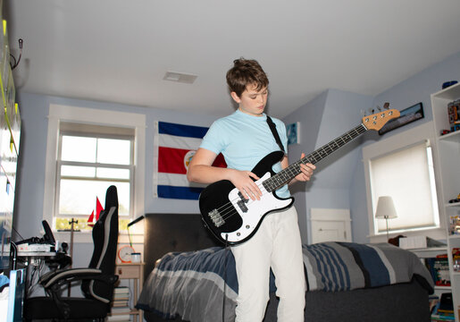 Portrait Teenager with electric music bass Musician  bedroom 