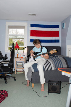 Portrait Teenager with electric bass  bedroom 