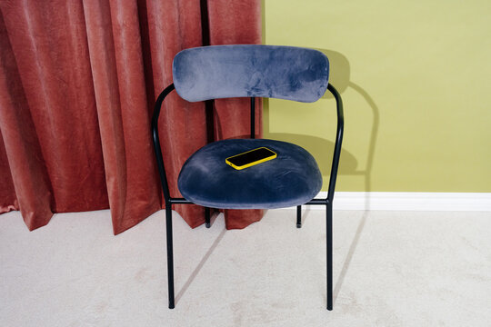 Smartphone Left on Upholstered Chair in Modern Interior