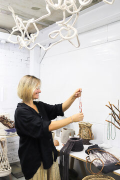 A woman is giving a master class on making bags.