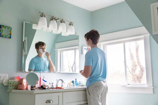 Portrait Teenager Lifestyle boy shaving first time bathroom