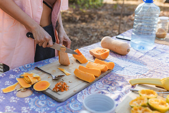 Preparing healthy butternut squash and oranges outdoors