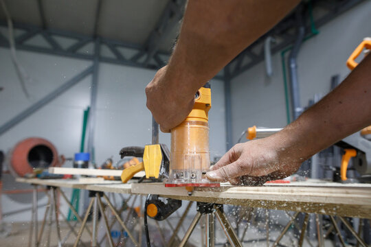 Man cut a bevel on a board