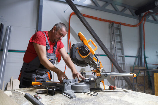 Carpenter works with a circular saw