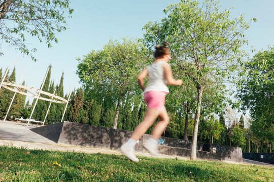 Girl running in park on sunny day