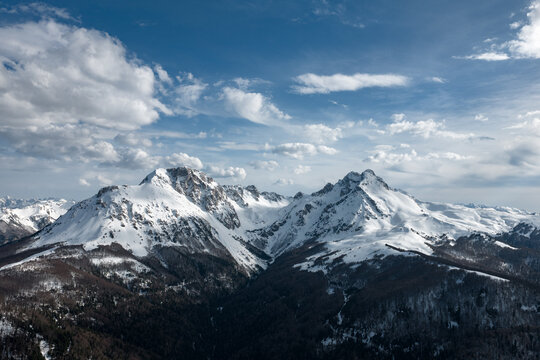 Snowy Mountain Range in Sunny Weather With Clouds in the Sky, drone 