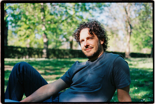 Man relaxing in park enjoying spring sunlight