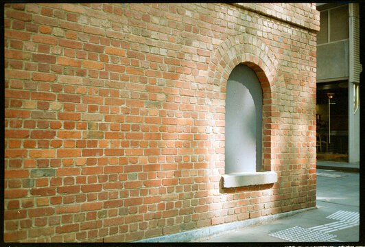 Beautiful light hits brick wall on city street.  Shot on film.