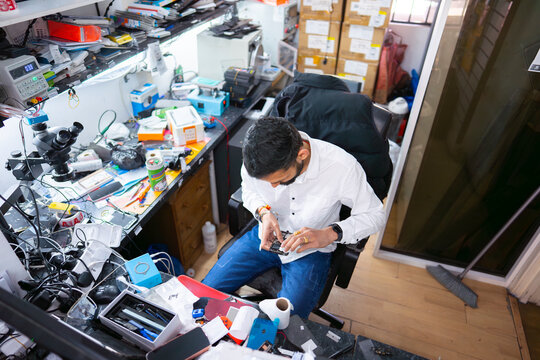 Busy electronics repair shop workspace