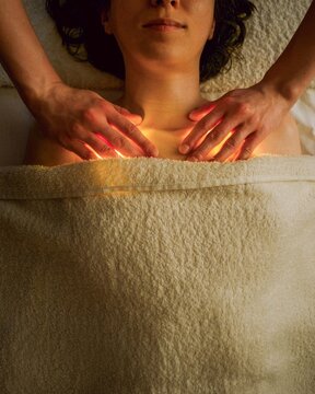 Woman Receives Treatment While Laying on Soft Towels in Spa