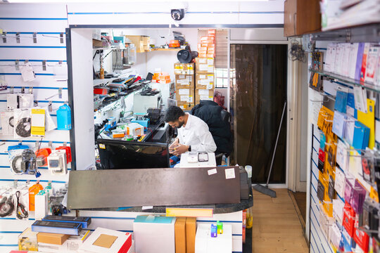 Busy phone repair shop with technician