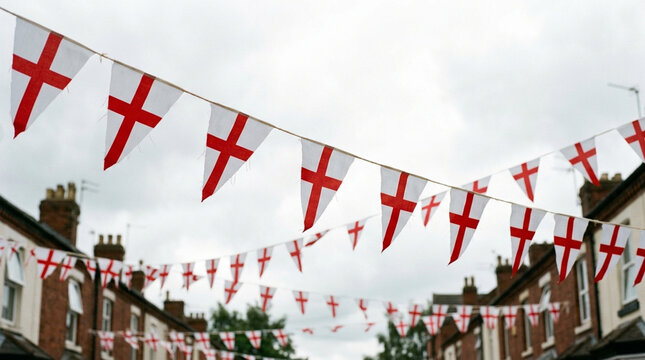 St George's Cross triangular bunting flags hanging across a residential street of traditional red brick terraced houses under an overcast sky, representing English national pride.