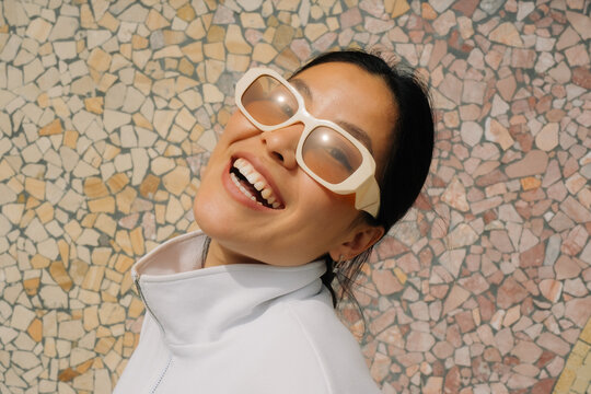 Happy Woman Wearing Sunglasses and Smiling