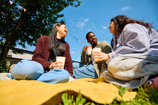 Friends Chatting Over Drinks at City Event