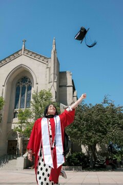 Student Celebrating Graduation- throwing grad cap