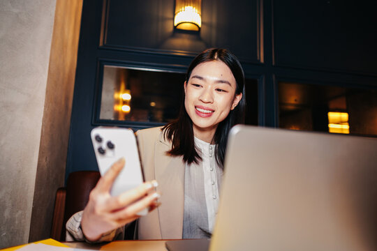 Checking Phone With Laptop