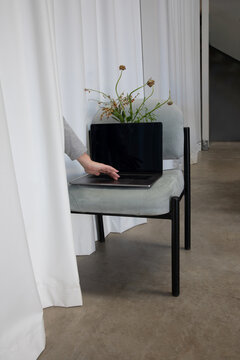 Work Space Set up With Laptop and Plant Near Curtain