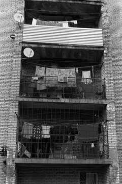 
B&W Film Photo of Residential Building Balconies with Laundry