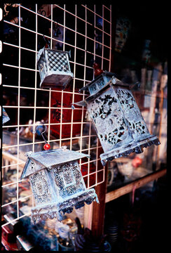 Metal Lanterns Hanging on a Display at a Market in the Evening