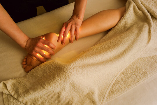 Person Receiving Massage on Ankle and Foot in a Treatment Room