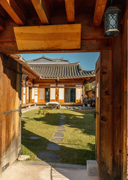 Courtyard view through wooden gate in Jeonju