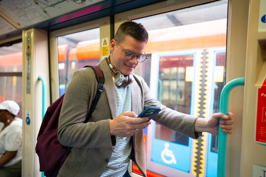 Man standing by train door during commute