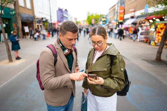 Tourists checking directions on smartphone