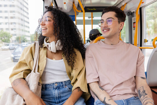 Young diverse students enjoying public bus transport ride