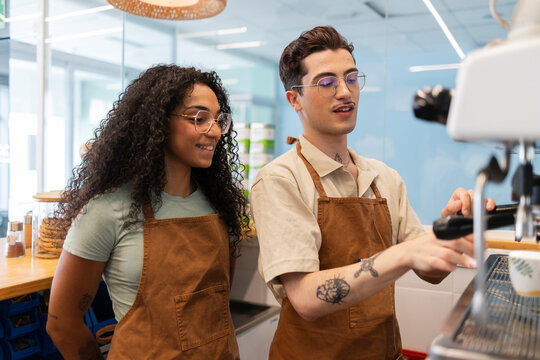 Baristas learning making coffee using espresso machine