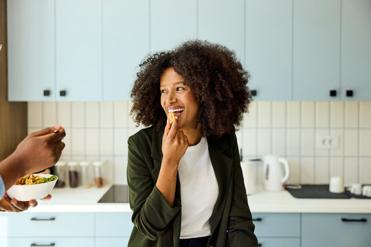 Businesswoman grabs a snack in the kitchen