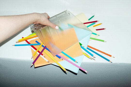 Contemporary office image of binder full of papers and pencils