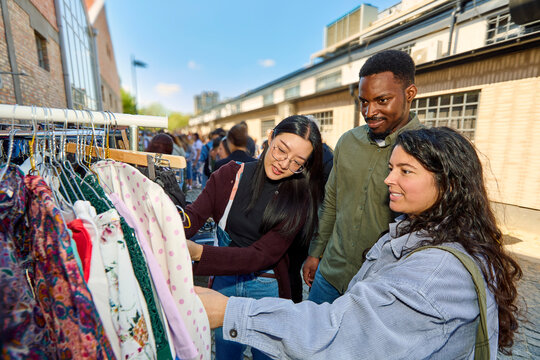 Friends Shopping for Clothes at Flea Market