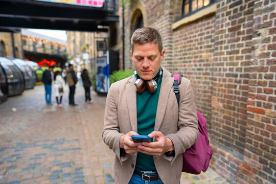 Man using smartphone while walking in city