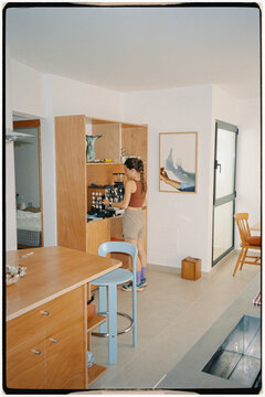 An athletic woman preparing specialty coffee at home