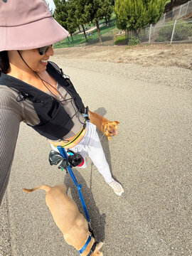 wide angle selfie of dog walker in running vest enjoying walk