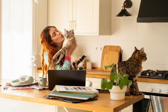 Woman Enjoys Time With Cats While Working from home